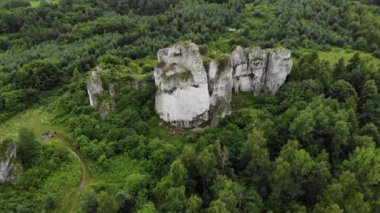 Arial view on a hole in the rock. Rocks. Forest in background. 4K, UHD, Cinematic