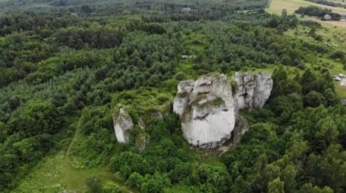 Arial view on a hole in the rock. Rocks. Forest in background. 4K, UHD, Cinematic