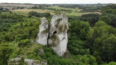 Arial view on a hole in the rock. Rocks. Forest in background. 4K, UHD, Cinematic