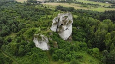 Arial view on a hole in the rock. Rocks. Forest in background. 4K, UHD, Cinematic