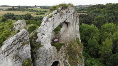 Arial view on a hole in the rock. Rocks. Forest in background. 4K, UHD, Cinematic