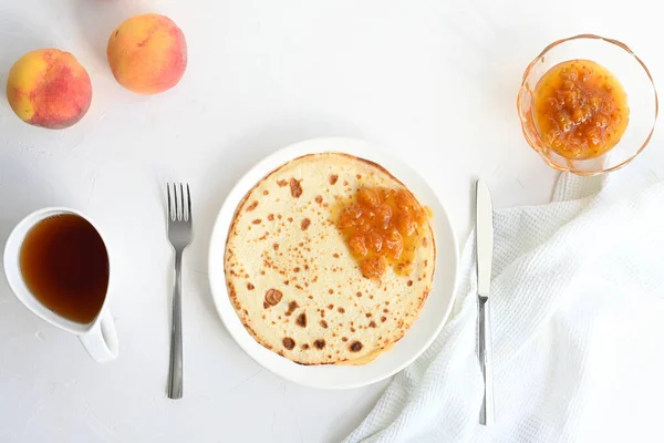 Große Pfannkuchen Mit Marmelade Tee Und Pfirsichen Auf Weißem Hintergrund — Stockfoto