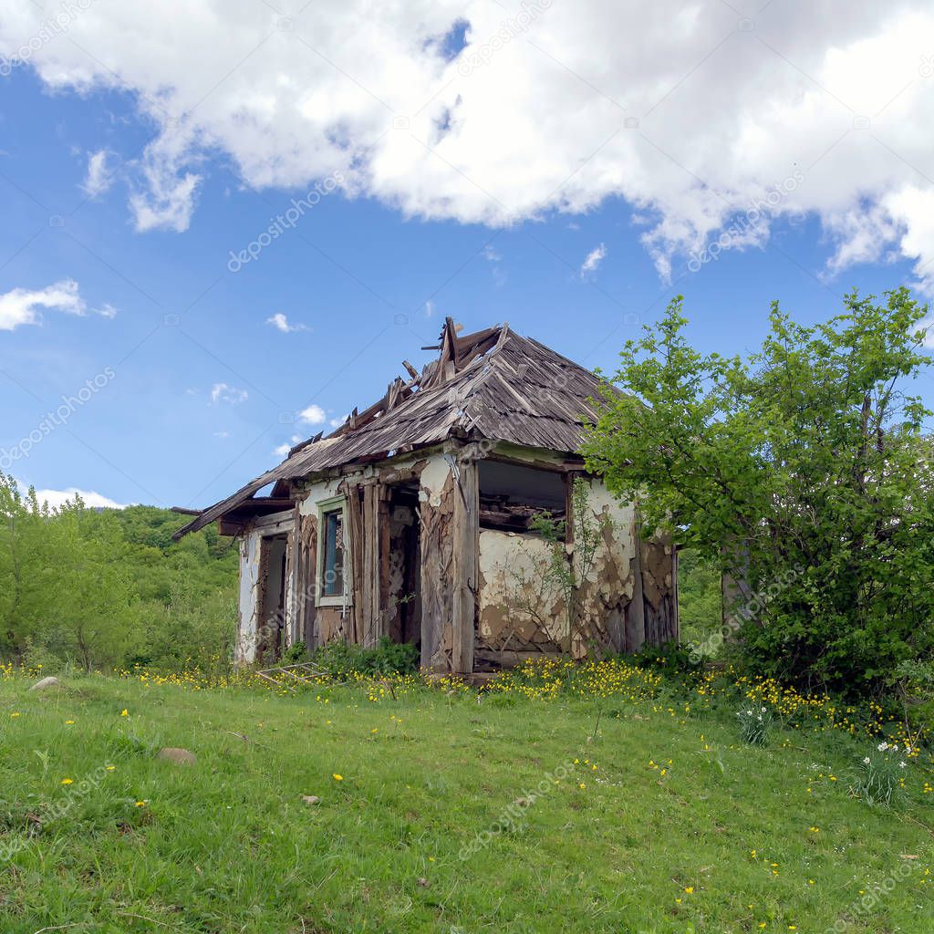 Summer,old abandoned farmer's house in nature,grass,sun.