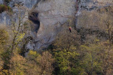  Maikop Regoin Adigeia,Rusya Federasyonu 10.28.2018 : Cesur insanlar çelik tel üzerinde bir dağ uçurumunun üzerinden uçuyor.