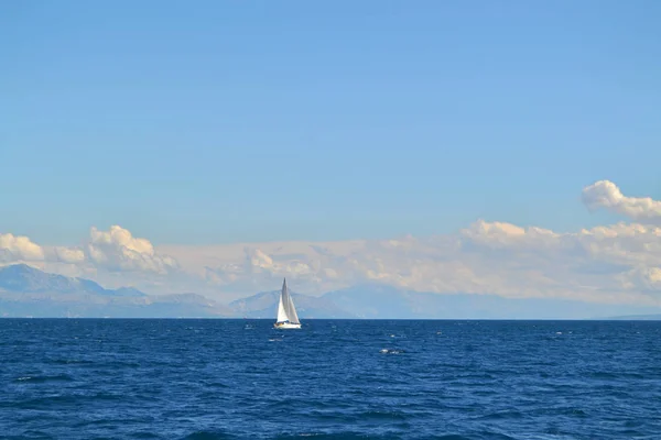 Sailing yacht and the sea. Land outline in the distance. Blue sky. Croatia.