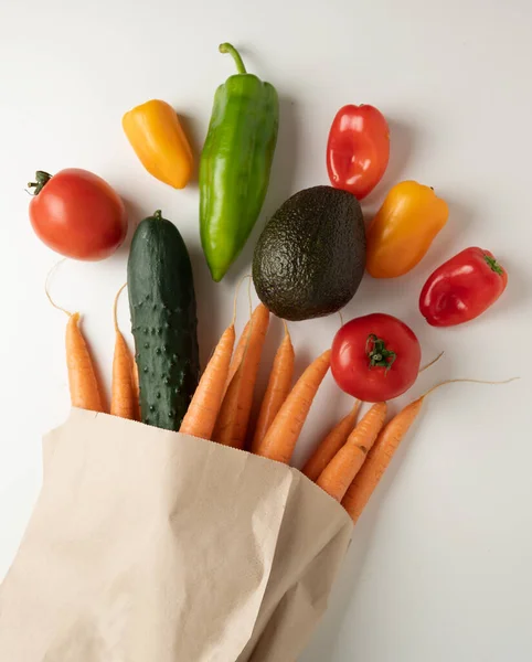 Fresh vegetables in recyclable paper bag isolated from the background