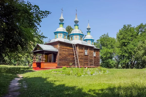 stock image Old Ukrainian church, open-air museum near Pereiaslav-Khmelnytskyi, Ukraine. Old wooden church painted with blue paint