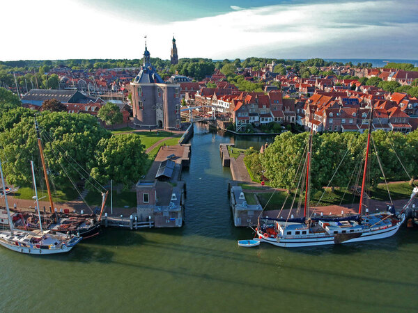 ENKHUIZEN,HOLLAND -6 JUNI 2019: drone photo of the harbor of enkhuizen with sailing boats a lock and tower the drommedaris and an old white drawbridge. Photo taken with a dji spark drone.