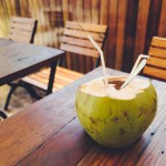 Open coconut on an open cafe table. Raw food