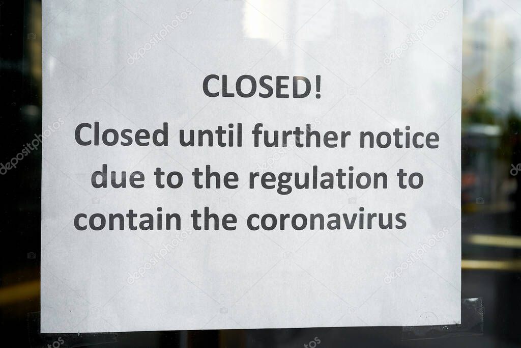 Sign on the front door of a closed hotel in Berlin during the Corona pandemic                               