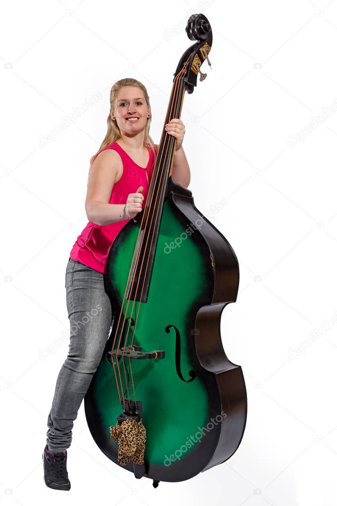 Female musician with red shirt plays on a double bass 