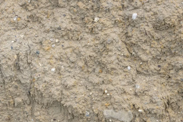 Sand wall of light sand with small pebbles