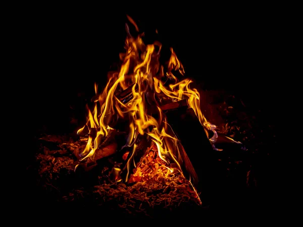 Bright burning fire in front of black background Royalty Free Stock Photos