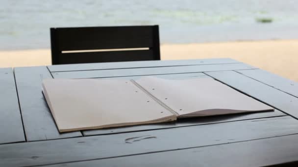 Wind Turns Pages Blank Notepad Lying Table — Stock Video