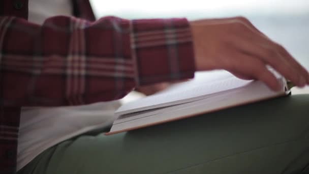 Man Flips Page While Reading Book — Stock Video