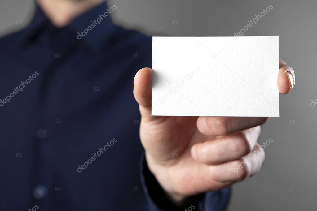 A man holding white business card