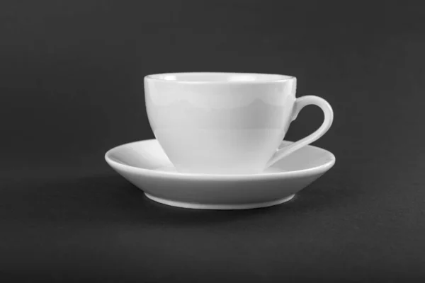 White mug and saucer on a gray background. — Stock Photo, Image