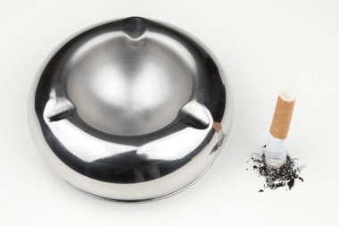 Stubbed cigarette butt stub with ash on white background