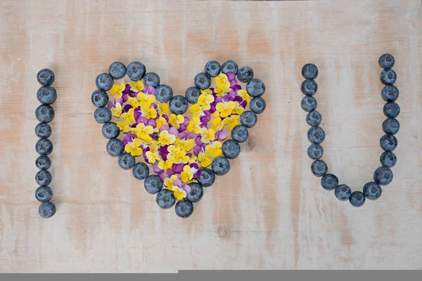 Love You Text Formed Big Blueberries Horned Violet Blossoms Wooden — Stock Photo, Image