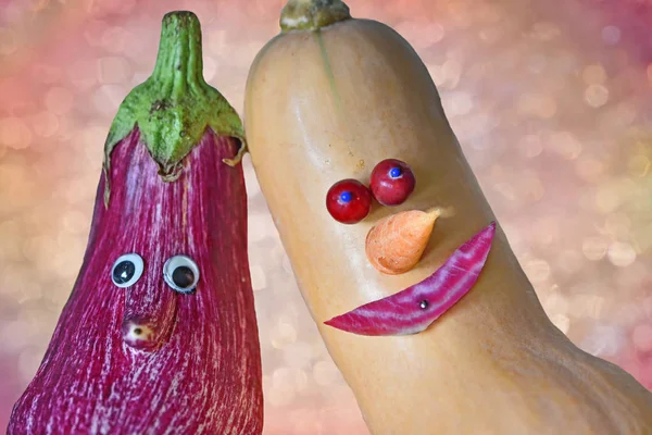 two cool vegetable dudes with funny faces, aubergine and butternut calabash. healthy food, creative arranged for kids.