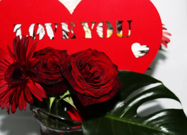 Big red heart with beautiful red roses for romantic card decoration.