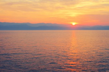 Amazing blue Ionian Sea at sunrise in Sidari holiday village on Corfu island in Greece ,Europe clipart