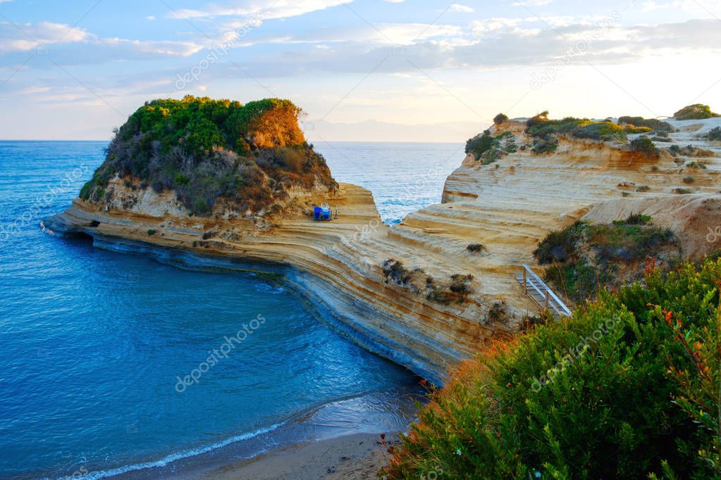 Famous Canal d'Amour beach with beautiful rocky coastline in amazing blue Ionian Sea at sunrise in Sidari holiday village on Corfu island in Greece