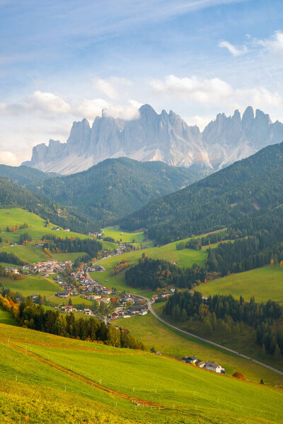 Typical beautiful landscape in the Dolomites,Santa Maddalena village, Val di Funes valley in the background with the Odle mountains in Italy