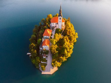 Aerial view of beautiful Lake Bled in the middle of the charming little island and the wonderful church at summer sunrise in Slovenia clipart
