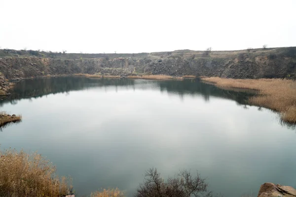 Una Cava Piena Acqua Con Una Riva Rocciosa Canne Germogliate — Foto Stock