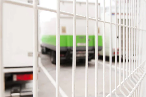 Loading-bay with trucks behind a lattice