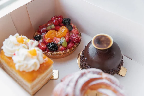 A variety of cakes in a box