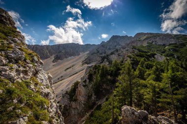 Klosterwappen, en yüksek tepeye kadar Schneeberg, Raxalpe, Aşağı Avusturya yakınındaki dramatik, bulutlu gökyüzü ile moloz sahada muhteşem manzarası