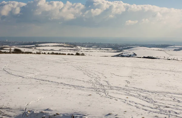 The South Downs covered in snow. View looking south from Devils Dyke near Brighton, East Sussex, England with the sea, coast and Brighton city.