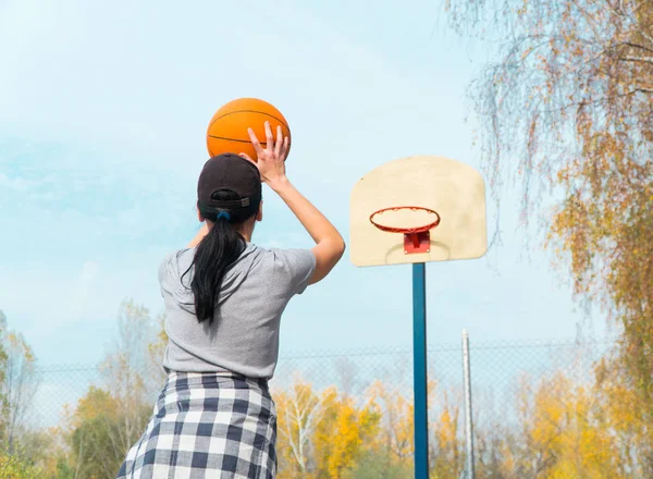 stock image Girl basketball player throws the ball up