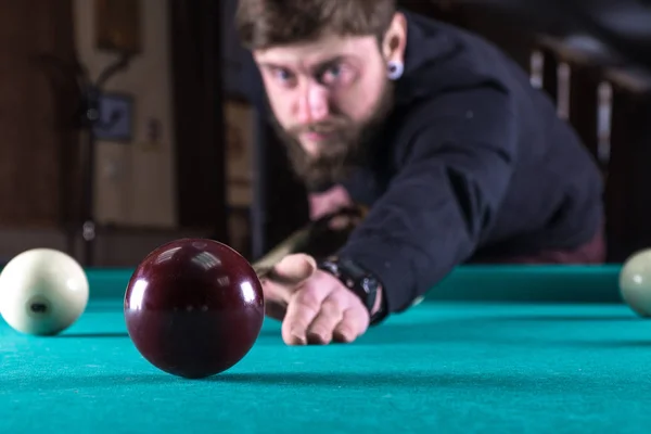 a man plays a game of pool. pool. scoring the ball.