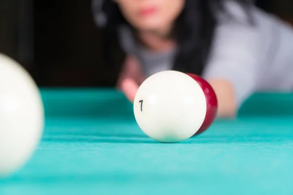 woman playing billiards. cue and billiard balls.