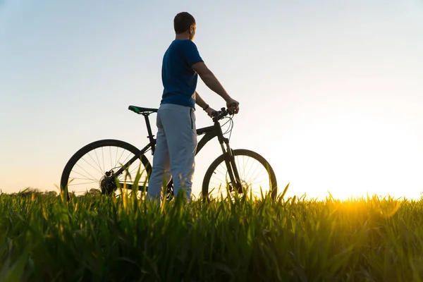 man on bike. sunset bike. bike at sunset.
