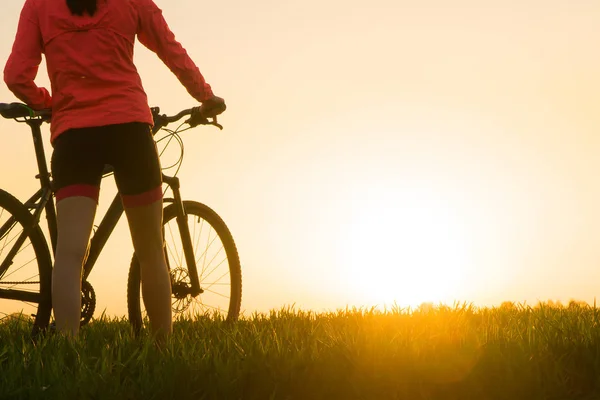woman at sunset from sunset Bike bike. woman practicing sports.