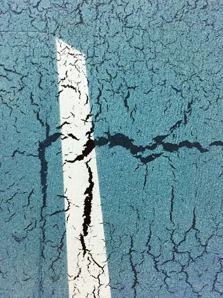 Rough metallic surface with scratches and cracks, (cyan background with white stripe)