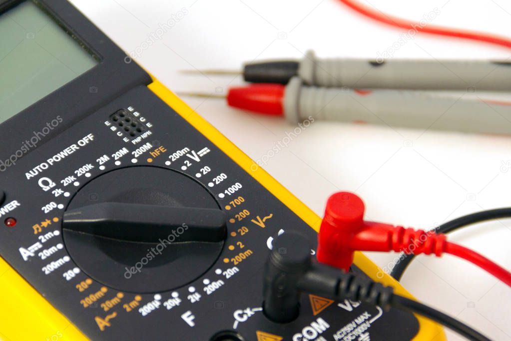 Digital multimeter with red and black probe, display turned off. Isolated on a white background. Close-up view