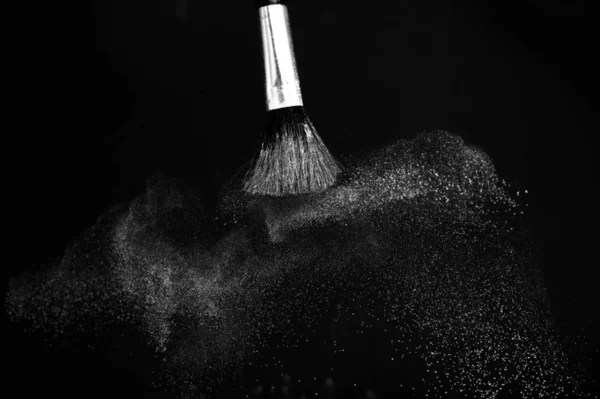 Cosmetic brush with white cosmetic powder spreading