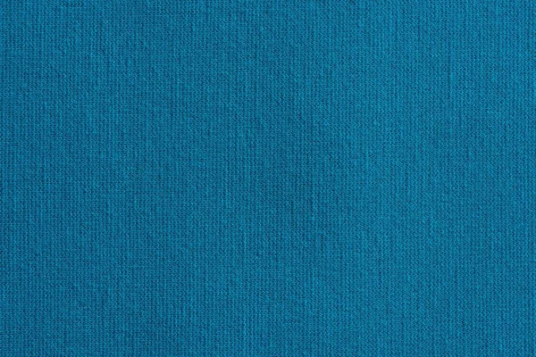 texture of a knitted cloth or textile material closeup for a uniform background or for wallpaper of fashionable turquoise blue color