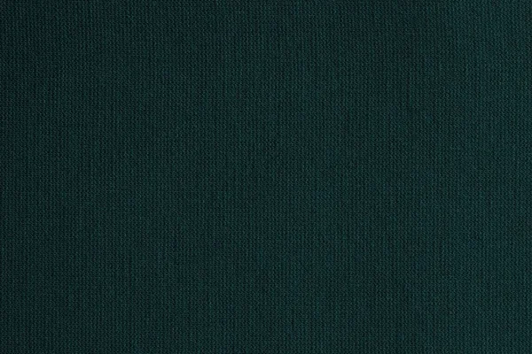 texture of a knitted cloth or textile material closeup for a uniform background or for wallpaper of fashionable dark emerald color