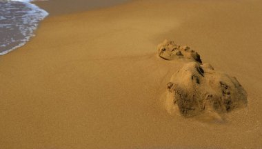 yıkanmış kum kumlu sahilden şekilsiz hill veya küçük bir yığın ile küçük sörf