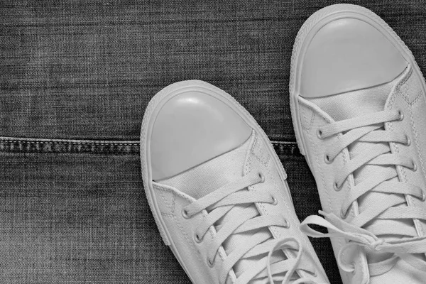 Fashionable gym shoes closeup on a jeans background — Stock Photo, Image