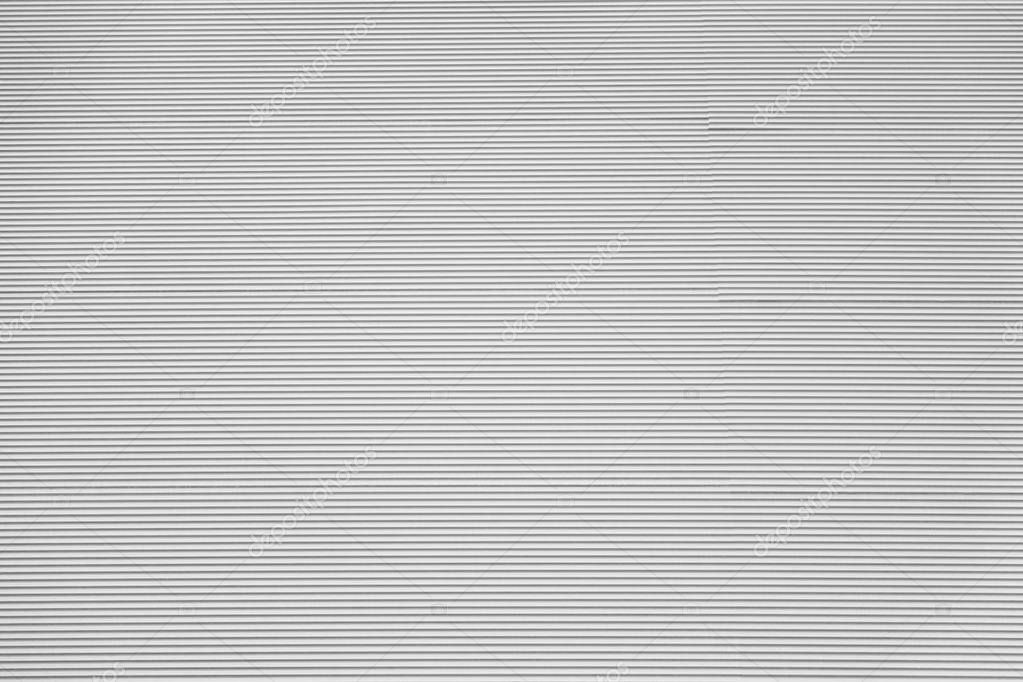 corrugated or rough wavy textured background of light gray color