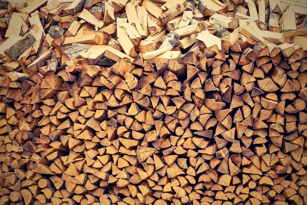 Wooden firewood in a stack with the textured end face. — Stock Photo, Image