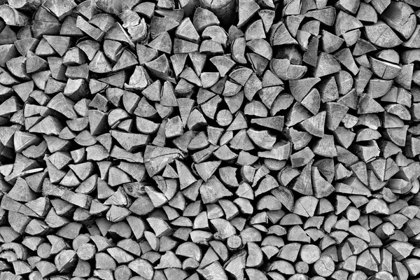 Wooden firewood in a stack with the textured end face of monochrome tone. — Stock Photo, Image