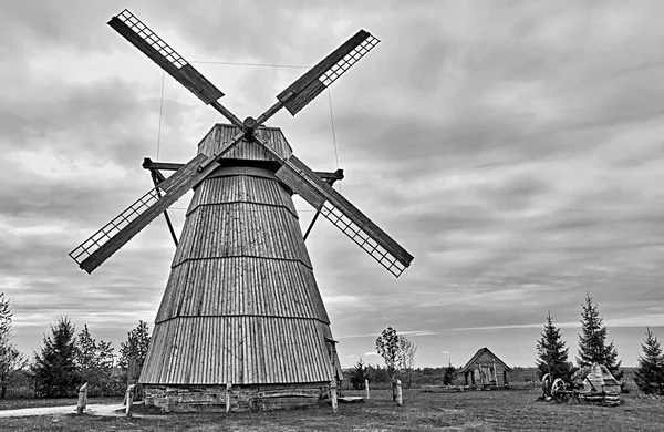 one old big wooden windmill on a photo in monochrome tone